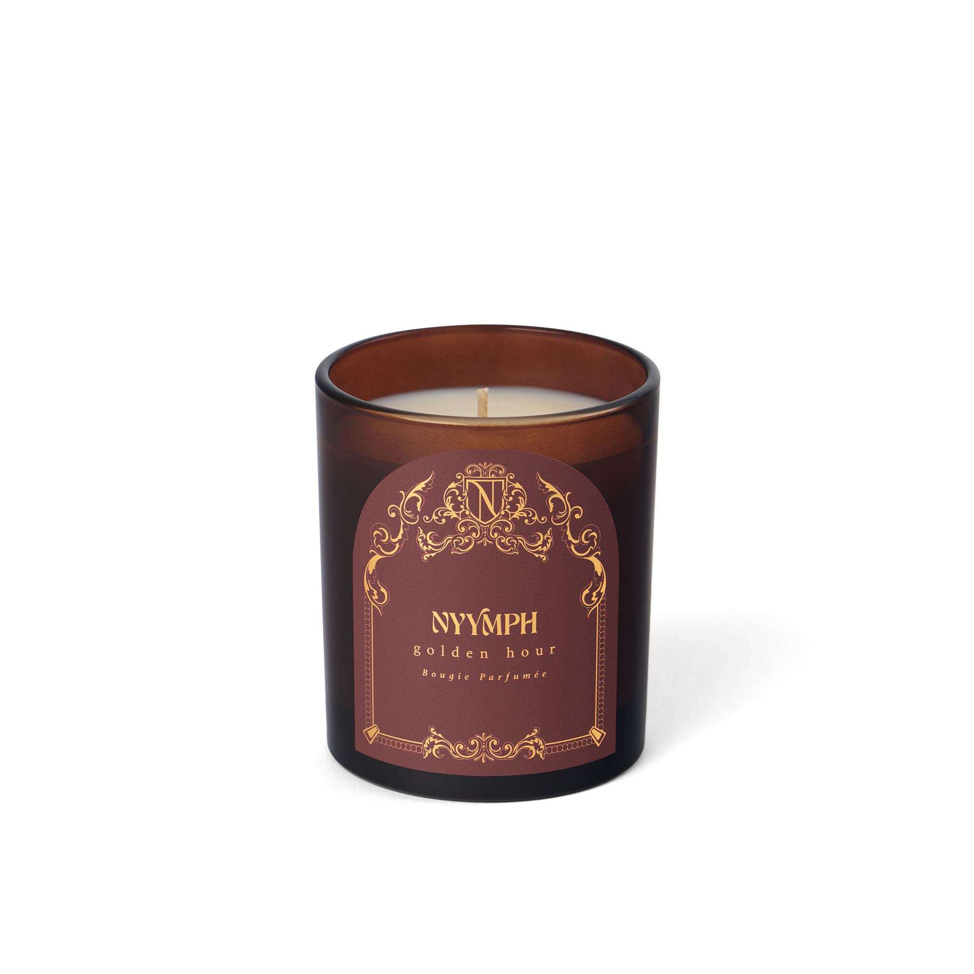 Golden Hour unlit candle by NYYMPH – maroon glass vessel with soy-coconut wax, elegant label and gold ornamentation.