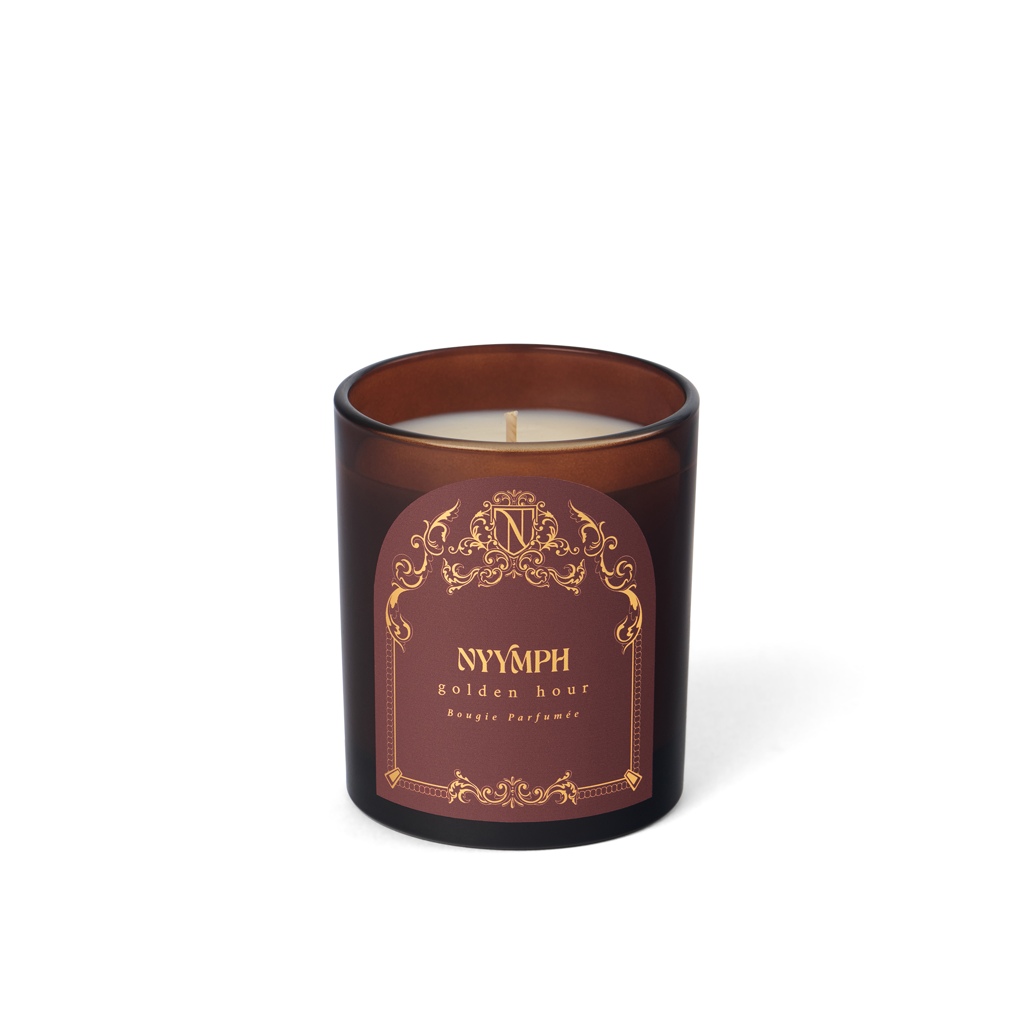 Golden Hour unlit candle by NYYMPH – maroon glass vessel with soy-coconut wax, elegant label and gold ornamentation.