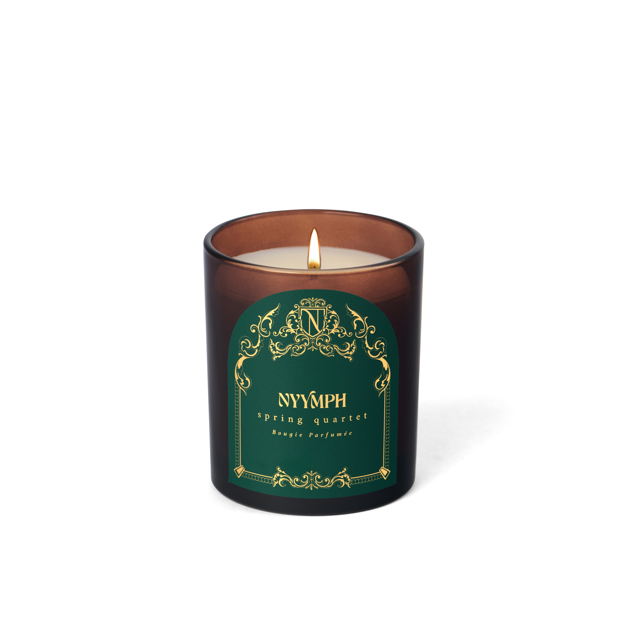 NYYMPH Spring Quartet scented candle lit in deep green and brown jar with gold details, shown against transparent background for sharp product view.